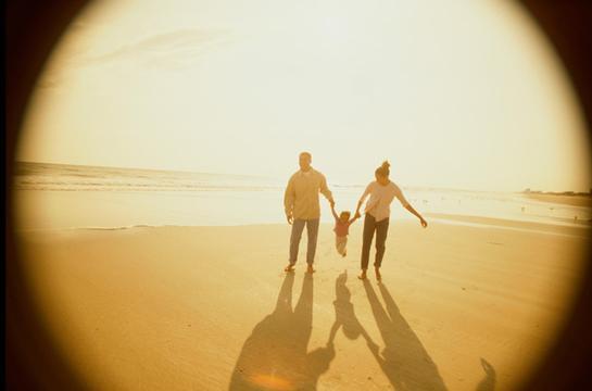 Father and mother with their daughter at the beach